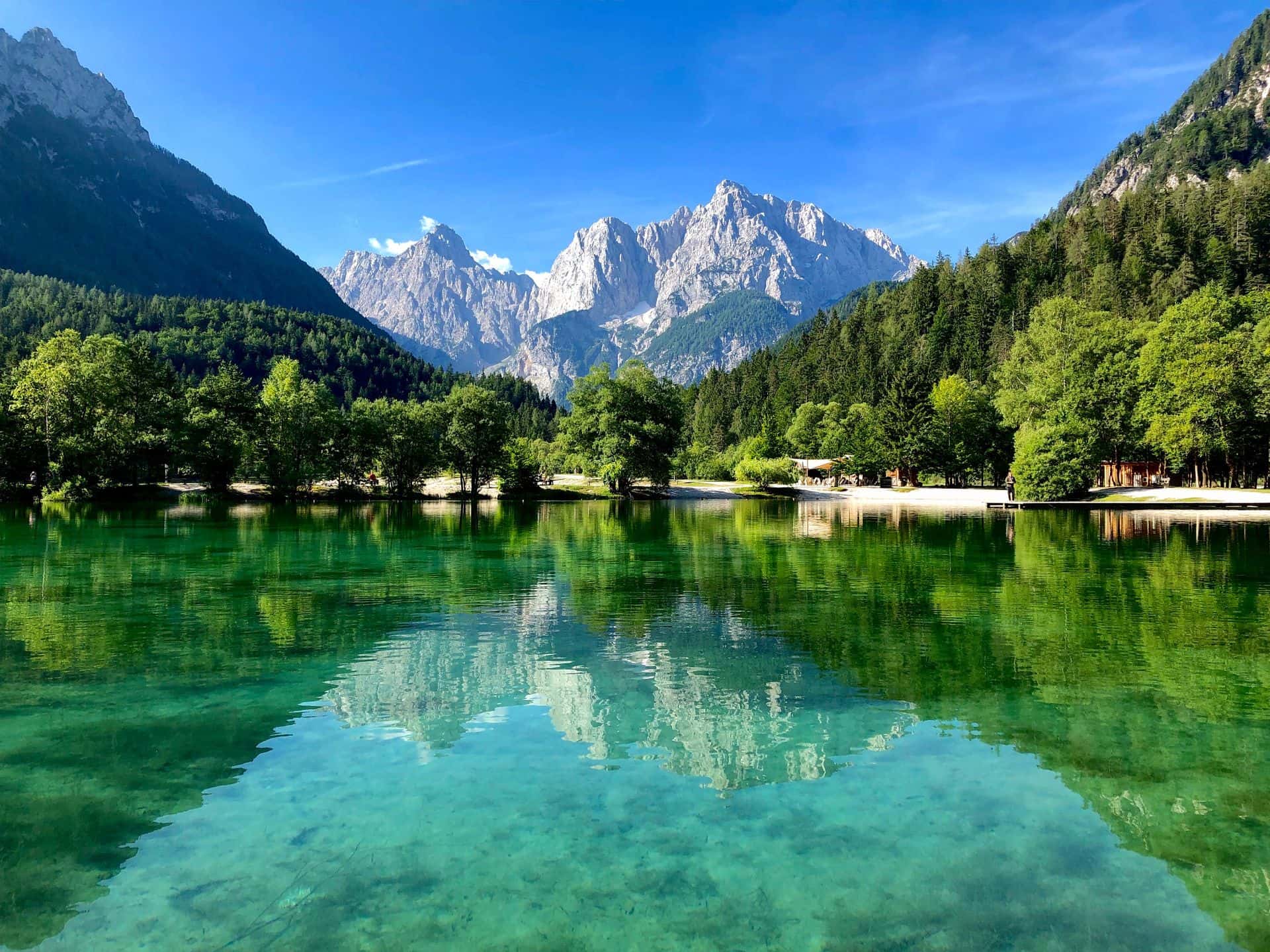 Turquoise water of Lake Jasna with the Julian Alps rising behind Kranjska Gora